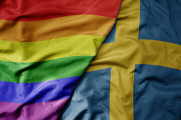 big waving realistic national colorful flag of sweden and rainbow gay pride flag .