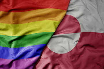 big waving realistic national colorful flag of greenland and rainbow gay pride flag .