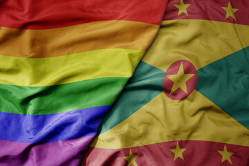 big waving realistic national colorful flag of grenada and rainbow gay pride flag .