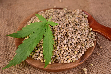 Hemp seeds in a wooden plate. Super food. Healthy food. Close-up.	