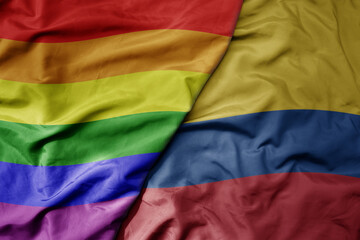 big waving realistic national colorful flag of colombia and rainbow gay pride flag .