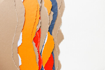 undulating vertical torn paper edges and blank space for copy