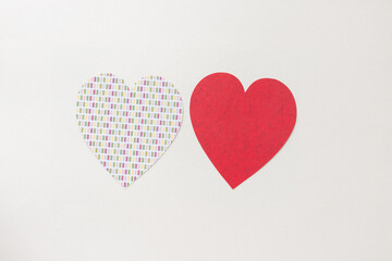 two hearts one with pattern the other red sharing and respecting the same graphical design space