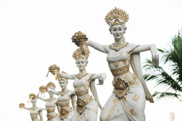 Traditional white stone statues, dancing women, Hindu religion, Hinduism, in Bali island.