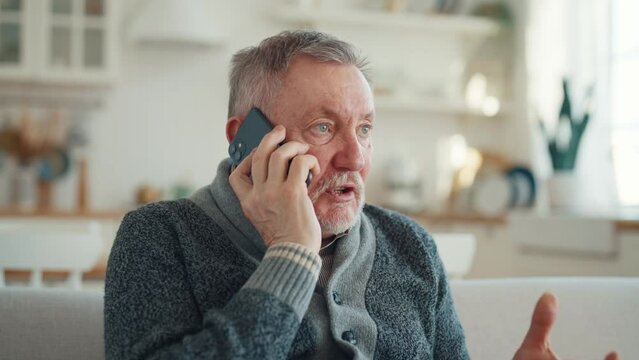 Portrait of outraged upset senior man talking on phone emotionally explaining problem. Stressed worried male hearing awful bad news calling smartphone, negative conversation, life problems concept.