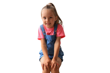 Excited child looking at camera while sitting on a transparent background
