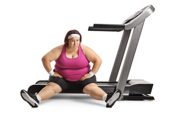 Lazy overweight woman sitting on a treadmill