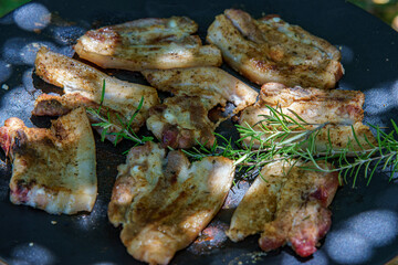 grilled pork meat with spices, on a grill