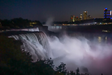 Niagara Falls, NY: The American Falls, the Horseshoe Falls (background), and hotels on the Canadian side of the gorge at night, from Prospect Point.
