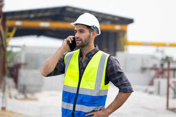 building and construction worker using mobile phone, Hiapanic latin male wearing safety hard hat...