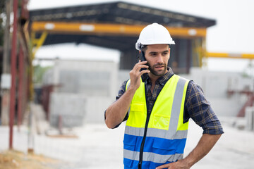 building and construction worker using mobile phone, Hiapanic latin male wearing safety hard hat...