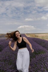 Beautiful Caucasian woman posing in a field of lavender flowers