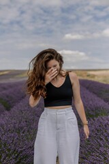 Beautiful Caucasian woman posing in a field of lavender flowers
