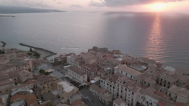 4k 25fps footage: aerial view of the medieval village of Pizzo in Calabria with its Murat castle, the Caribbean sea, the highway behind. The town is overlooking the sea.