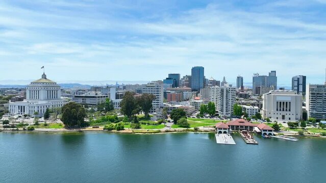 Boom up from Lake Merritt aerial to view of Oakland City and distant San Francisco
