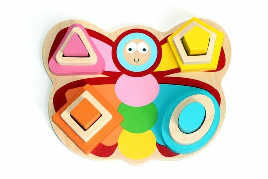 Image is of a vibrant wooden butterfly toy designed for children