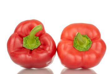 Two red bell peppers, macro, isolated on white background.