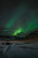 Fototapeta na wymiar aurora borealis in the night sky above Reykjavik, Iceland, with stars twinkling in the background