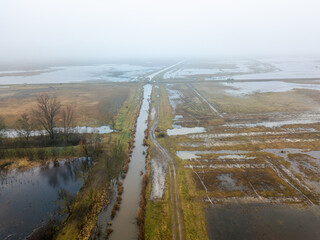Agricultural land flooded with water after snowmelt. Photo taken with a drone.