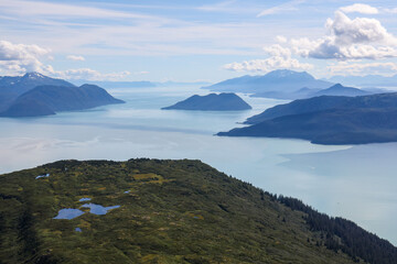 Aerial photo of a mountain peak near Juneau, Alaska with Gastineau Channel and Stephens passage in the background.