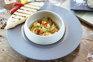 Shrimp pil-pil. King prawns, garlic, chilli and baguette. Delicious Spanish traditional food closeup served for lunch in modern gourmet cuisine restaurant