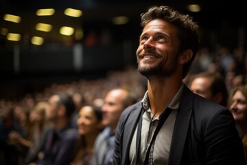 Fototapeta premium A man is asking a question to a speaker during a Q&A session at an international technical conference in a darkened auditorium. the young expert shows off