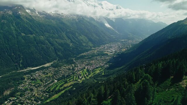 Landscape scene of vegetation green of Valley Chamonix Alps with a snowy top and blue cloudy sky