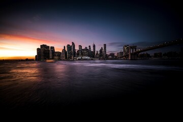 Obraz premium Beautiful view of the city of Manhattan during sunset, with the sun casting an orange hue