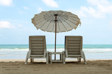 Beach umbrellas and sunbeds on the sand. The concept of rest, sea and vacation. White cloud...