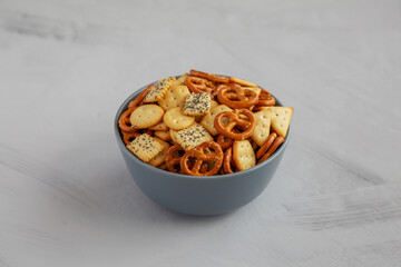 Homemade Party Snack Mix with Crackers and Pretzels in a Bowl, side view.