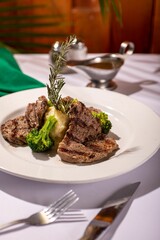 Delicious meal of meat and broccoli served on a white plate, ready to be enjoyed