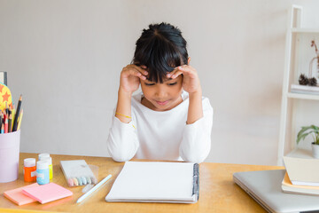  young Asian female college student preparing for the exam. Depressed young woman student.