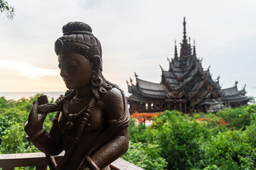 Sanctuary of Truth, Pattaya, Thailand, wooden temple by the ocean during sunset on beach of...
