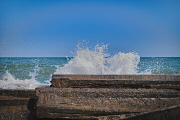 Splash from the waves breaking on the granite embankment