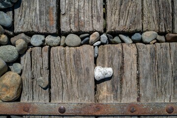 some pebbles on a wooden walkway in Newgale Beach, Pembrokeshire, UK