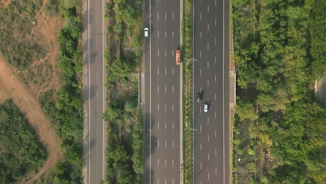 Aerial view of a highway with vehicles. Fly-over shot of an expressway. 4K drone footage of a motor freeway. 