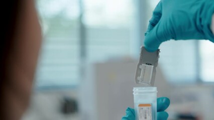 Scientist holding a genome cartridge cell in the lab for research