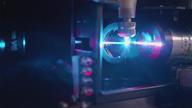 Closeup of a purple  laser cutting Quantum engineering machine