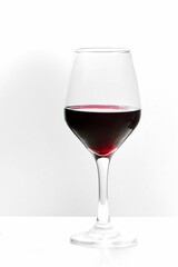 Glass of red wine on a white background