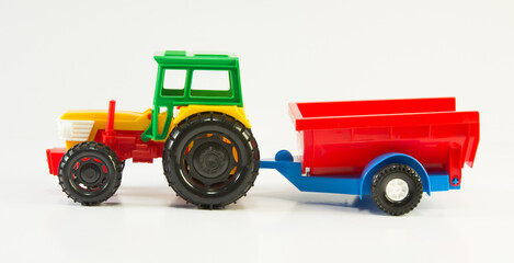 Toy plastic colorful tractor with trailer