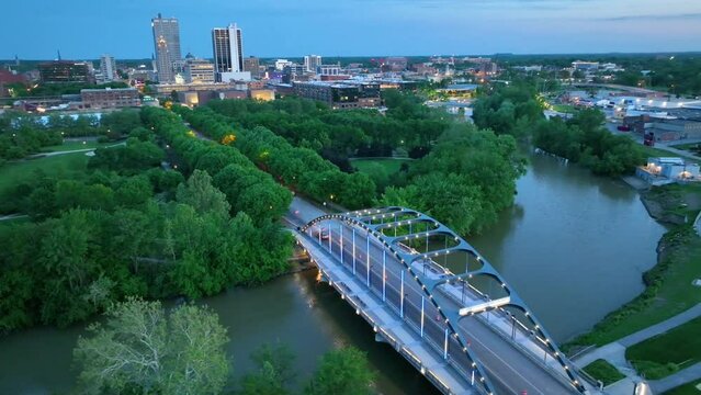 Arc aerial video around Martin Luther King Jr Bridge at dusk with city lights