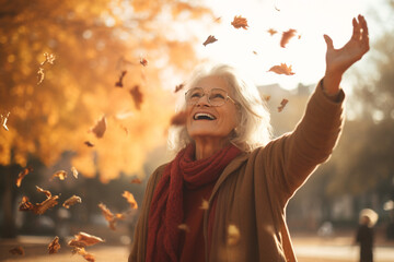 Senior woman with arms outstretched enjoying nature in park. High quality photo