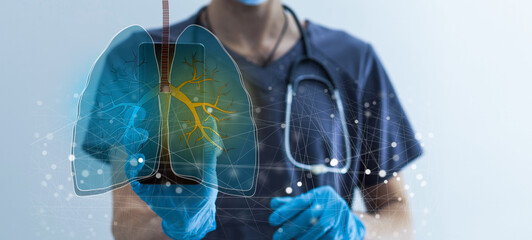 Close up of female doctor holding tablet with abstract glowing lung interface with virus outline on...