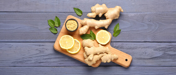 Board with fresh ginger roots, powder and slices of lemon on dark wooden background