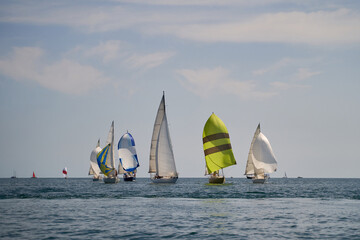 Fototapeta premium Sailing yacht regatta. Many sailing yachts in a row. sailing yachts under gennaker, speaker, genoa