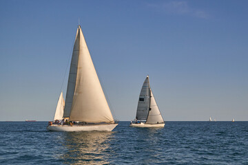 Fototapeta premium Sailing yacht regatta. Many sailing yachts in a row. sailing yachts under gennaker, speaker, genoa
