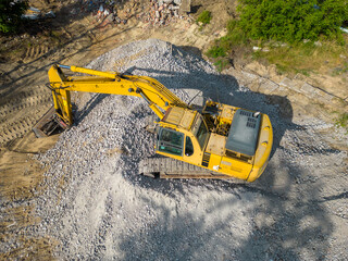 aerial view of rubble of an old building. Demolition of a building. Dismantling of a building. Excavator demolishing old buildings.	
