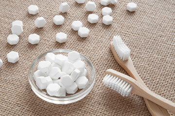 White solid toothpaste tablet with bamboo toothbrush