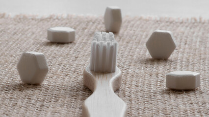 White solid toothpaste tablet with bamboo toothbrush