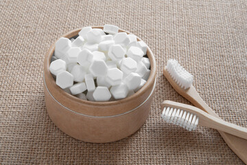 White solid toothpaste tablet with bamboo toothbrush